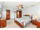 Cozy bedroom featuring a ceiling fan and access to hallway with carpet flooring at 8534 Helmsman Cir, Indianapolis, IN 46256