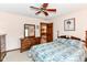 A carpeted bedroom featuring a mirror, dresser, and floral bedding at 8534 Helmsman Cir, Indianapolis, IN 46256
