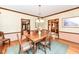 Elegant dining room with wood floors, wainscoting, and multiple access points to other rooms at 8534 Helmsman Cir, Indianapolis, IN 46256
