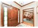 Inviting home foyer with hardwood floors, decorative trim, and views into the dining room at 8534 Helmsman Cir, Indianapolis, IN 46256