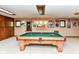 Spacious game room with a well-maintained pool table under a Notre Dame light fixture at 8534 Helmsman Cir, Indianapolis, IN 46256