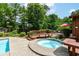 Backyard patio featuring a relaxing hot tub with a wood deck and landscaping at 8534 Helmsman Cir, Indianapolis, IN 46256
