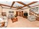 Inviting living room featuring exposed wood beams, neutral decor, and staircase at 8534 Helmsman Cir, Indianapolis, IN 46256