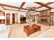 Spacious living room with beamed ceilings, a brick fireplace, and staircase at 8534 Helmsman Cir, Indianapolis, IN 46256