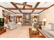 Bright living room featuring beamed ceilings, fireplace, and staircase at 8534 Helmsman Cir, Indianapolis, IN 46256