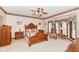 This main bedroom offers a bay window, ceiling fan, and plush carpeting at 8534 Helmsman Cir, Indianapolis, IN 46256