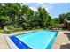 A beautiful in-ground pool and landscaped backyard with mature trees and a hot tub at 8534 Helmsman Cir, Indianapolis, IN 46256