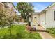 Charming backyard with a picket fence, yellow door, landscaping, and inviting deck at 905 Buchanan St, Indianapolis, IN 46203