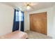 Bedroom with a twin bed, closet, blue curtains and a ceiling fan at 905 Buchanan St, Indianapolis, IN 46203