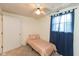 Bedroom featuring a twin bed, neutral carpet and walls, ceiling fan and natural light from a window at 905 Buchanan St, Indianapolis, IN 46203