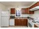Well-equipped kitchen with white appliances, wooden cabinets, and ample counter space at 905 Buchanan St, Indianapolis, IN 46203
