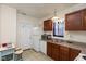 Functional kitchen with white appliances, wooden cabinets, and a convenient eat-in area at 905 Buchanan St, Indianapolis, IN 46203