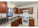 Updated kitchen with stainless steel microwave, wooden cabinets, and a bright window at 905 Buchanan St, Indianapolis, IN 46203