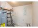 Efficient utility area featuring a water heater, shelving, and functional workspace at 905 Buchanan St, Indianapolis, IN 46203