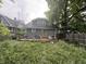 Exterior of house with deck and overgrown lawn at 917 N Rural St, Indianapolis, IN 46201
