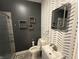 Stylish bathroom features trendy wallpaper, framed mirror, and modern fixtures at 917 N Rural St, Indianapolis, IN 46201