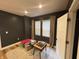 Bedroom with brown walls, two windows and wood floors at 917 N Rural St, Indianapolis, IN 46201