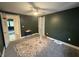 Bedroom with two doors and a ceiling fan overlooking neutral carpet floors at 917 N Rural St, Indianapolis, IN 46201