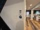 Inviting hallway with thermostat, light switch, and hardwood flooring leading to kitchen at 917 N Rural St, Indianapolis, IN 46201
