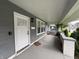 View of the home's front porch with a white front door and exterior light at 917 N Rural St, Indianapolis, IN 46201