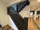 Dark stained staircase with wooden floors and white walls, offering a classic look at 917 N Rural St, Indianapolis, IN 46201