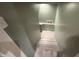 A bright stairwell featuring wood-look floors and light green walls at 917 N Rural St, Indianapolis, IN 46201