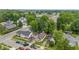 A slightly higher aerial perspective captures the home’s position amidst tree-lined streets and a mix of residential buildings at 1011 W 7Th St, Anderson, IN 46016