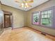 Inviting bedroom with hardwood floors, ceiling fan, and a large window offering ample natural light at 1011 W 7Th St, Anderson, IN 46016