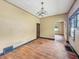 A dining room showcasing hardwood floors, traditional light fixture, and cream-colored walls at 1011 W 7Th St, Anderson, IN 46016
