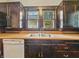 Close-up of the kitchen featuring hardwood countertops, dark cabinets, and a stainless steel sink at 1011 W 7Th St, Anderson, IN 46016