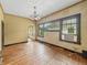 Spacious living room featuring hardwood floors, a decorative chandelier, and natural light from large windows at 1011 W 7Th St, Anderson, IN 46016