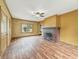 Bright living room with a brick fireplace, hardwood floors, and views into adjacent rooms at 1011 W 7Th St, Anderson, IN 46016