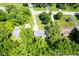 An aerial view showing the position of this home on a spacious lot with mature trees and a long driveway at 1015 Fox Hill Dr, Indianapolis, IN 46228