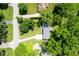 Aerial view of a home nestled among trees, showcasing a well-maintained lawn and convenient access to roads at 1015 Fox Hill Dr, Indianapolis, IN 46228