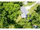 Aerial view showcases this home's well-maintained roof, spacious lot with mature trees, and grassy lawn at 1015 Fox Hill Dr, Indianapolis, IN 46228