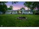 Large backyard featuring a firepit and covered patio, perfect for relaxing and entertaining outdoors at 1015 Fox Hill Dr, Indianapolis, IN 46228