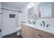 Bathroom boasts double sinks, white tile, shower, and sleek black fixtures at 1015 Fox Hill Dr, Indianapolis, IN 46228