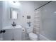 Bathroom showcasing white fixtures, decorative mirror, and a shower-tub combo at 1015 Fox Hill Dr, Indianapolis, IN 46228