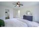 Bright bedroom featuring white walls, ceiling fan, a dresser, and an ensuite bathroom at 1015 Fox Hill Dr, Indianapolis, IN 46228