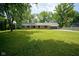 Charming brick ranch home with a well-manicured lawn, mature trees, and an attached two car garage at 1015 Fox Hill Dr, Indianapolis, IN 46228