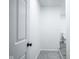 Hallway view of a well-lit hallway with gray carpet, offering a glimpse into a bathroom at 1015 Fox Hill Dr, Indianapolis, IN 46228