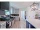 Modern kitchen featuring stainless steel appliances, stone countertops, and stylish lighting, perfect for cooking and entertaining at 1015 Fox Hill Dr, Indianapolis, IN 46228