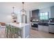 Updated kitchen with stainless steel appliances, island seating, and stylish lighting, designed for modern living at 1015 Fox Hill Dr, Indianapolis, IN 46228