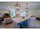 Spacious open-concept living area featuring a kitchen island, stylish lighting, and inviting decor, ideal for gatherings at 1015 Fox Hill Dr, Indianapolis, IN 46228