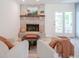 Cozy living room featuring a brick fireplace and access to backyard seating, ideal for relaxing and entertaining at 1015 Fox Hill Dr, Indianapolis, IN 46228