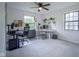 Bright home office features multiple desks, windows, and ceiling fan at 1015 Fox Hill Dr, Indianapolis, IN 46228