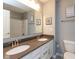 Bathroom featuring a double sink vanity, neutral colors, and decorative accents at 10334 Deercrest Ln, Indianapolis, IN 46239