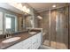 Modern bathroom featuring a glass-enclosed shower and double vanity with gray countertops at 10334 Deercrest Ln, Indianapolis, IN 46239