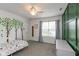 Bright bedroom featuring tree decals, a single bed, and a neutral color scheme at 10334 Deercrest Ln, Indianapolis, IN 46239