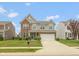 Charming two-story home featuring brick and vinyl siding, a well-manicured lawn, and an attached two-car garage at 10334 Deercrest Ln, Indianapolis, IN 46239